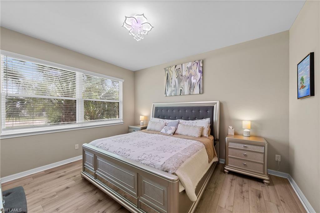 9366 Pocida Court, Unit 202 Naples, FL 34119 - Photo 16 of 44 a bedroom with a bed and a window