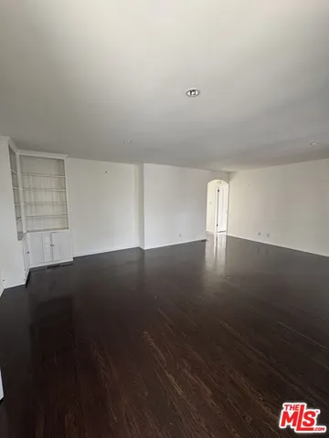 a view of an empty room and wooden floor