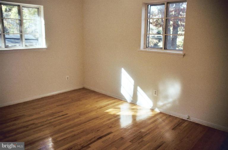 7426 Flora Street Springfield, VA 22150 - Photo 10 of 16 an empty room with wooden floor and windows