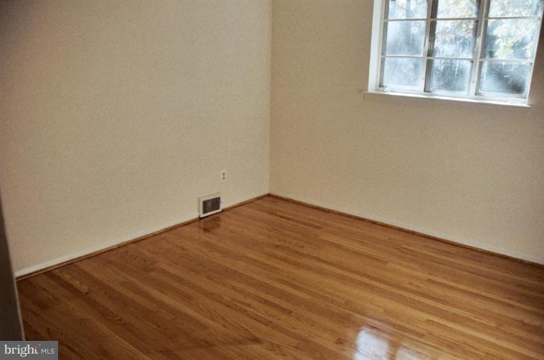 7426 Flora Street Springfield, VA 22150 - Photo 11 of 16 a view of empty room with wooden floor and fan
