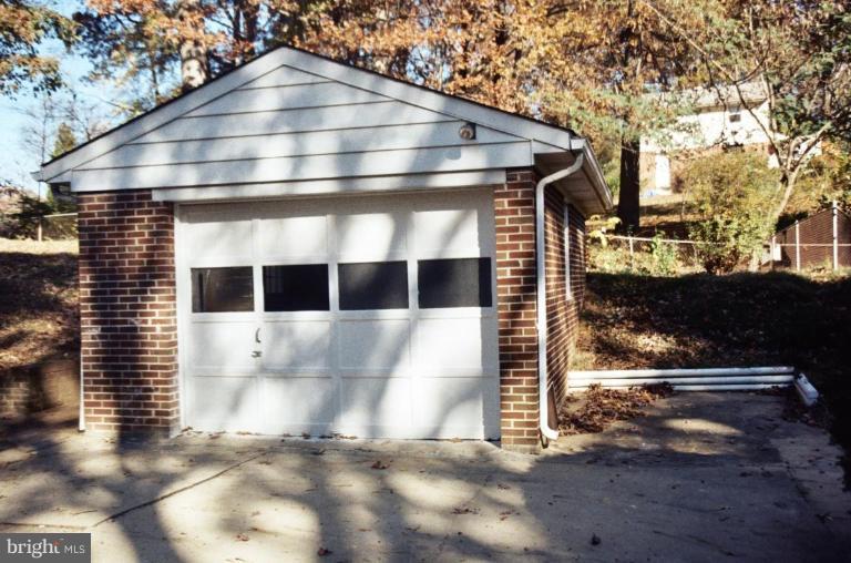7426 Flora Street Springfield, VA 22150 - Photo 14 of 16 a front view of a house with a yard