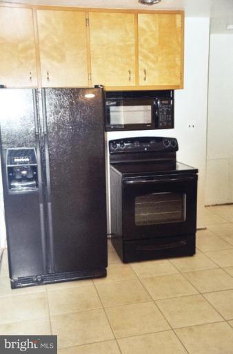 7426 Flora Street Springfield, VA 22150 - Photo 5 of 16 a stove top oven a refrigerator and a sink