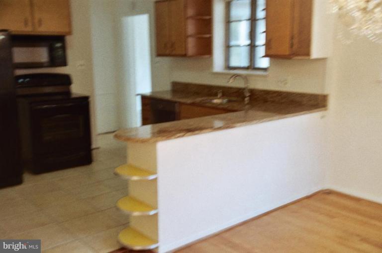 7426 Flora Street Springfield, VA 22150 - Photo 16 of 16 a kitchen with a sink and a stove top oven