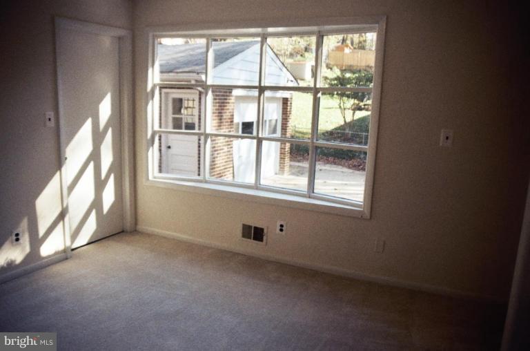 7426 Flora Street Springfield, VA 22150 - Photo 7 of 16 a view of an empty room with a window