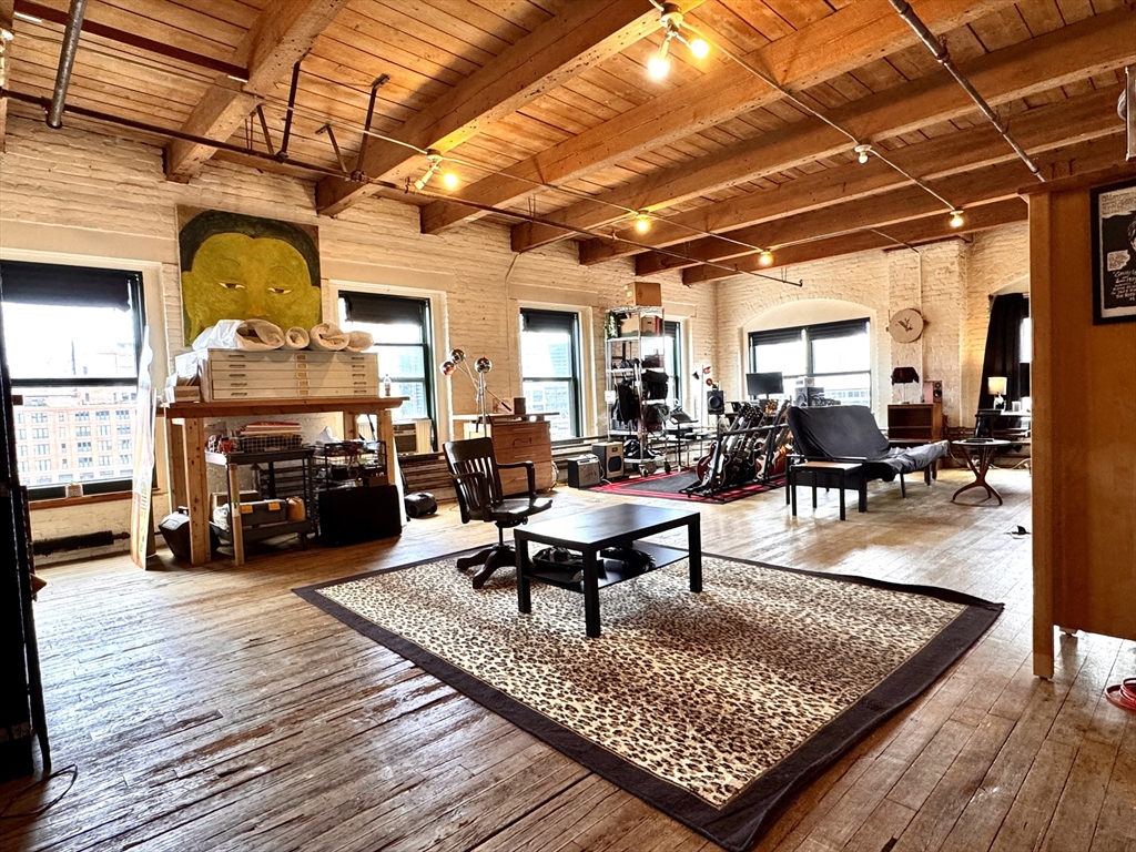 a living room with lots of furniture and a chandelier