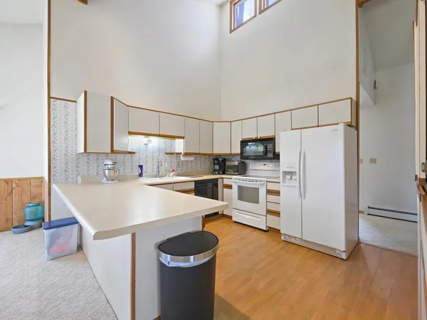 a kitchen with stainless steel appliances a refrigerator and a stove top oven