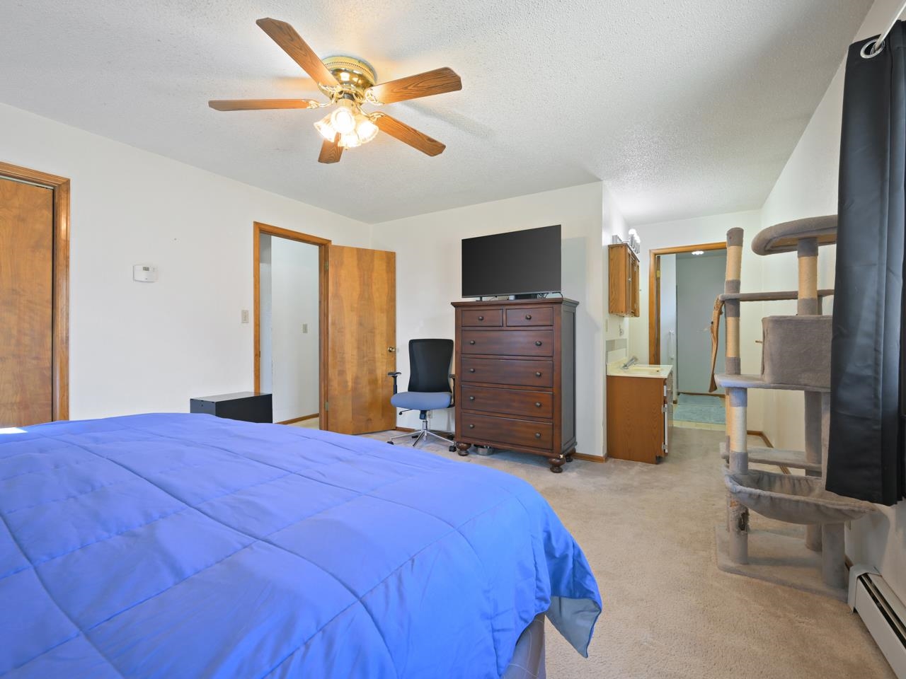 750 Pinyon Court Fruita, CO 81521 - Photo 19 of 40 a bedroom with a bed and a television
