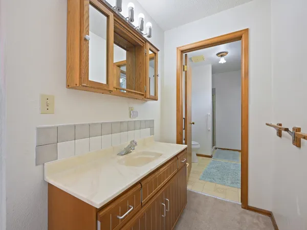 a white toilet sitting next to a bathroom sink