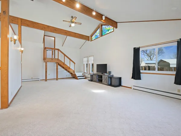 a view of a livingroom with furniture and staircase
