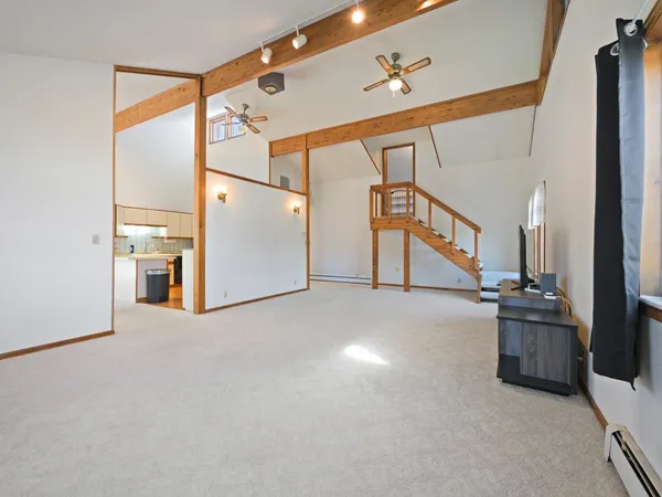 a view of a big room with closet and windows