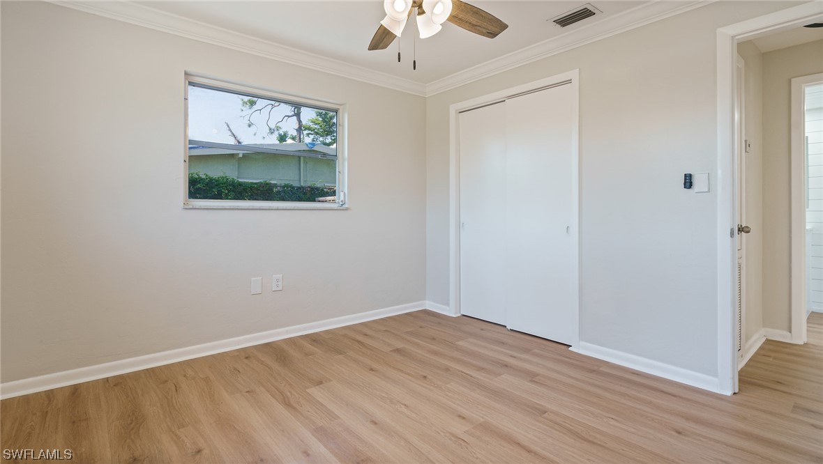 8631 Exeter Street Fort Myers, FL 33907 - Photo 14 of 23 a view of a hallway with wooden floor and workspace