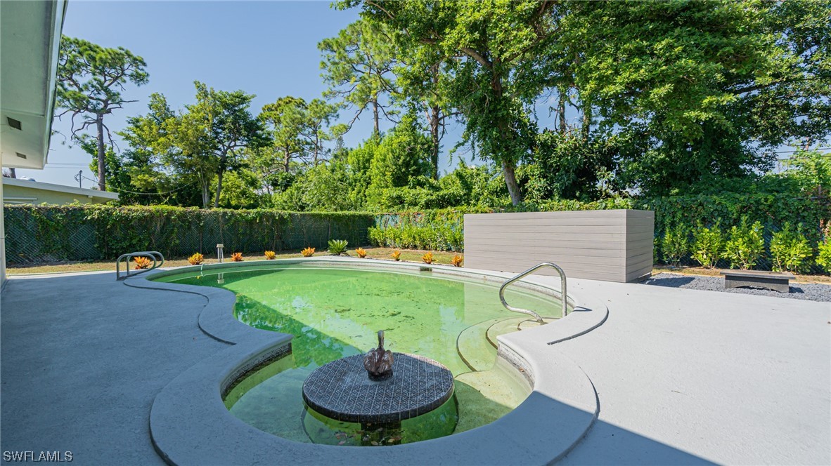 8631 Exeter Street Fort Myers, FL 33907 - Photo 20 of 23 a view of a swimming pool with a yard and plants
