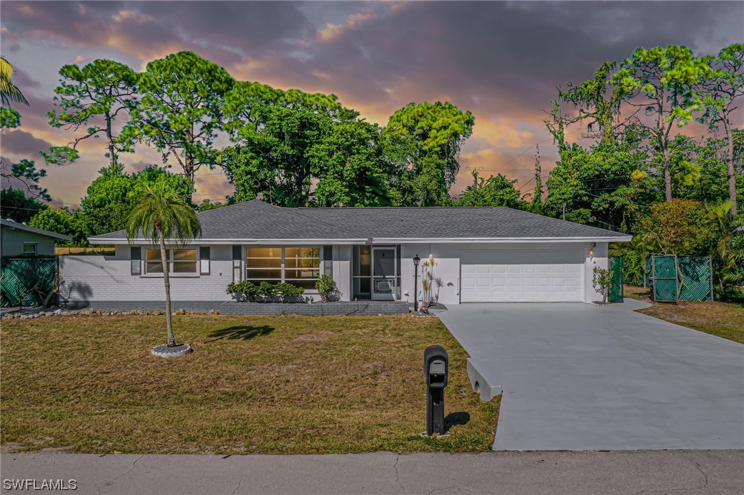 8631 Exeter Street Fort Myers, FL 33907 - Photo 2 of 23 front view of house with a yard