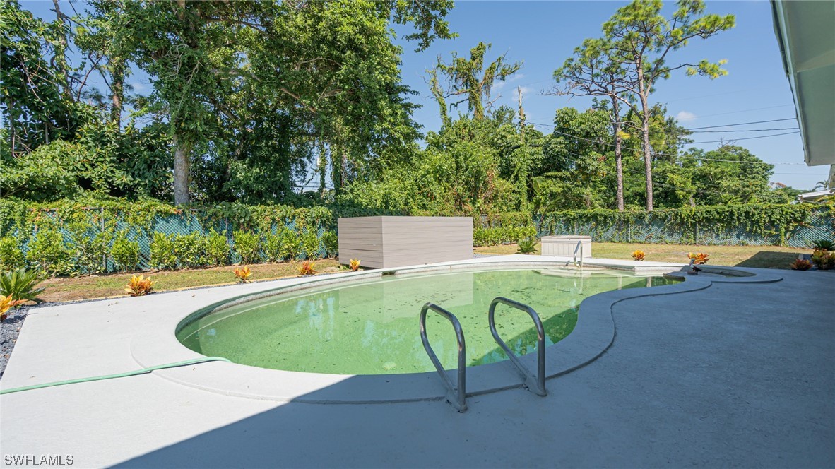 8631 Exeter Street Fort Myers, FL 33907 - Photo 21 of 23 a view of a swimming pool with a yard