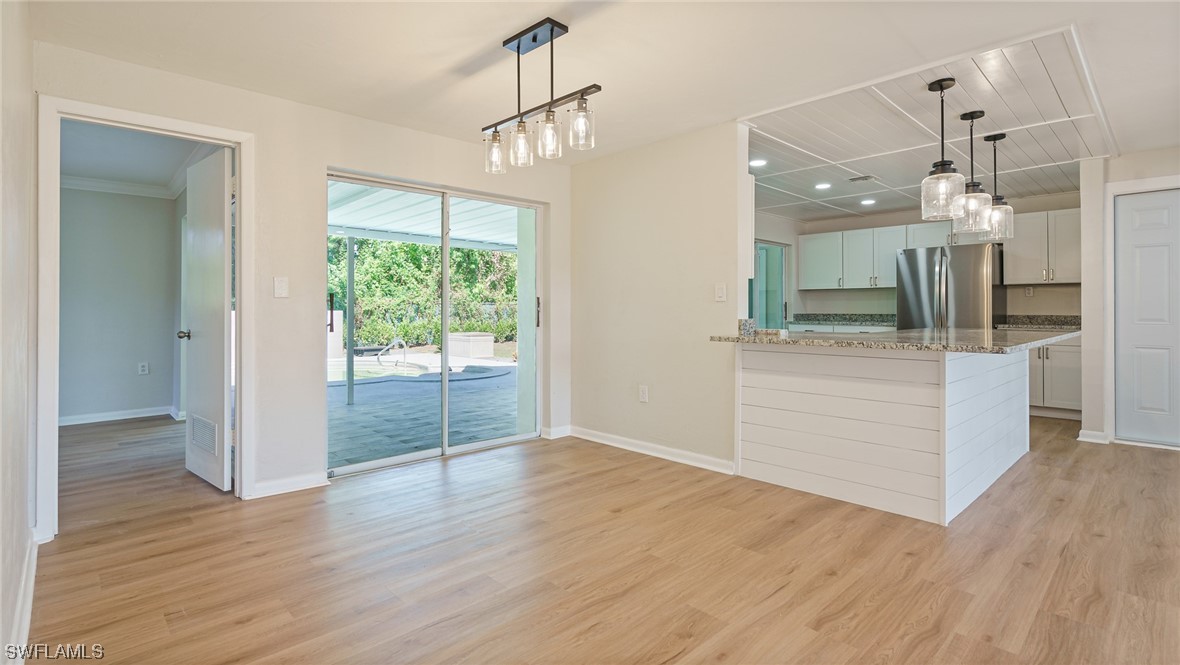 8631 Exeter Street Fort Myers, FL 33907 - Photo 6 of 23 a view of a kitchen with wooden floor and a sink
