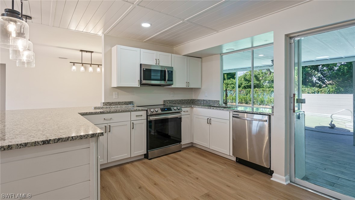 8631 Exeter Street Fort Myers, FL 33907 - Photo 8 of 23 a kitchen with a sink stove and microwave