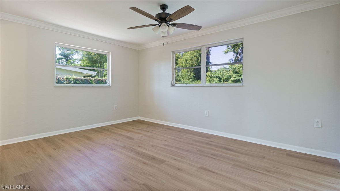 8631 Exeter Street Fort Myers, FL 33907 - Photo 10 of 23 a view of an empty room with wooden floor and a window