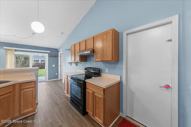 a kitchen with a stove a sink and a refrigerator