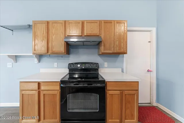 a kitchen with a stove and a microwave