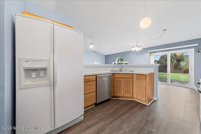 a kitchen with a sink cabinets and wooden floor
