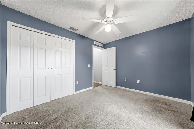 a view of an empty room with a fan
