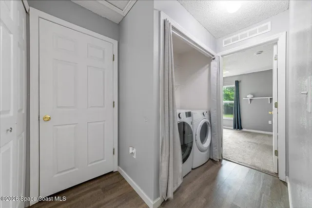 a view of a hallway with washer and dryer