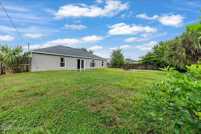 a view of a house with backyard and garden