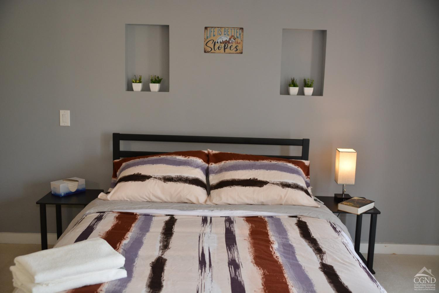 81 Scribner Hollow Road, Unit D 2 Hunter, NY 12442 - Photo 15 of 36 a bedroom with a bed and painting on the wall