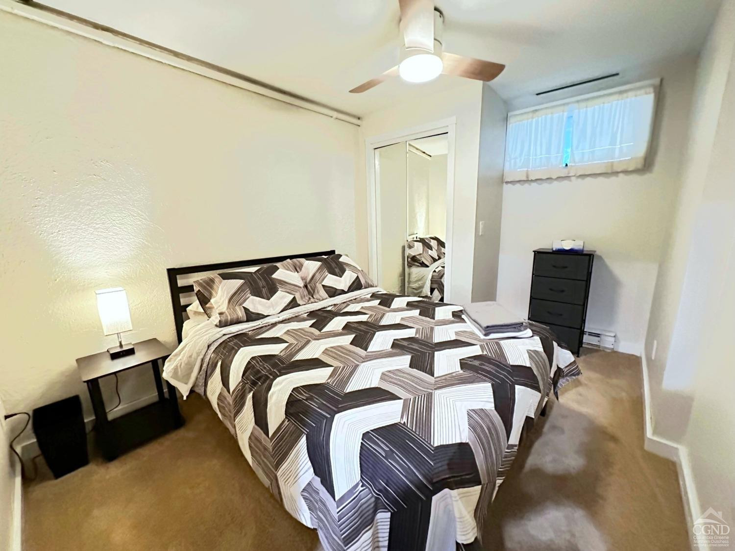 81 Scribner Hollow Road, Unit D 2 Hunter, NY 12442 - Photo 22 of 36 a bedroom with a bed and a chair