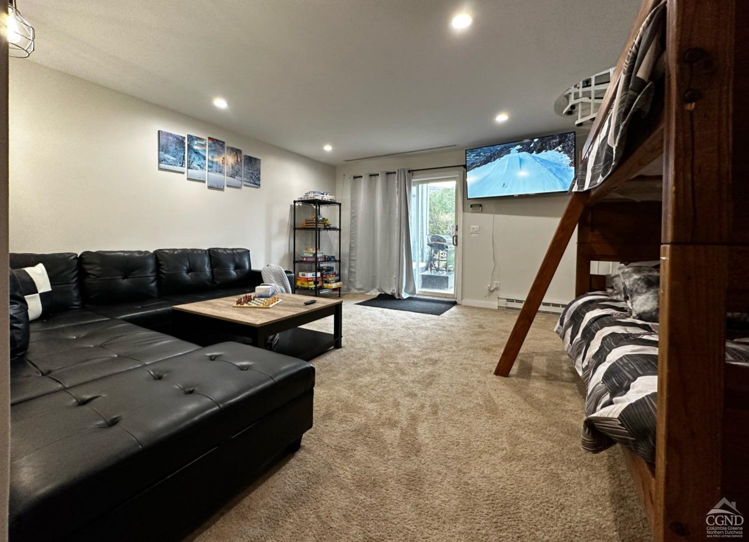 81 Scribner Hollow Road, Unit D 2 Hunter, NY 12442 - Photo 31 of 36 a living room with furniture and a flat screen tv