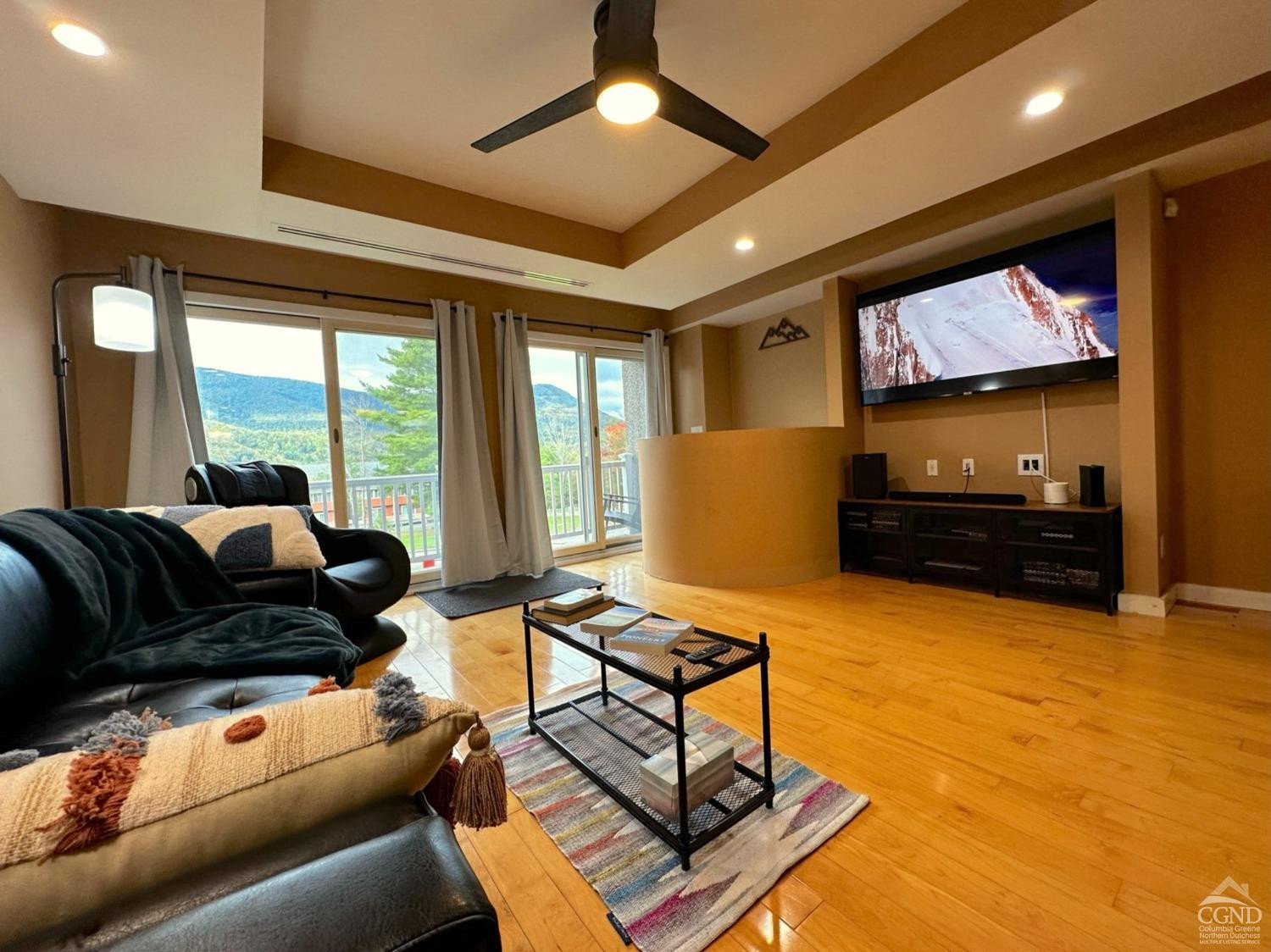 81 Scribner Hollow Road, Unit D 2 Hunter, NY 12442 - Photo 7 of 36 a living room with furniture and a flat screen tv