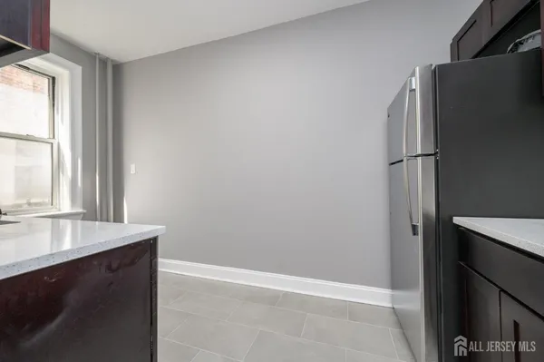 a view of a kitchen with a sink and a refrigerator