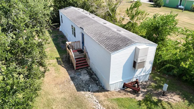 a aerial view of a house with a yard and sitting area