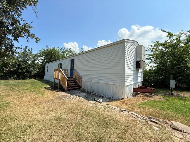 a backyard of a house with table and chairs