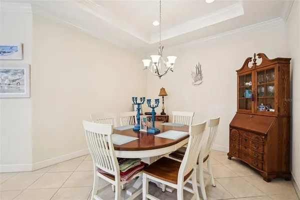 a dining room with furniture and chandelier