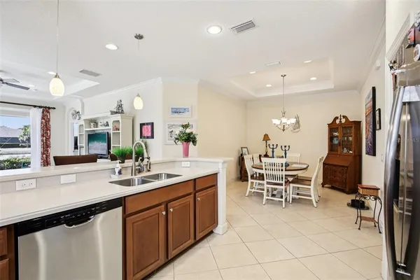 a kitchen with stainless steel appliances kitchen island granite countertop a sink and cabinets