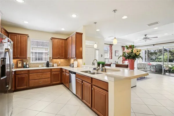 a large kitchen with a sink and cabinets