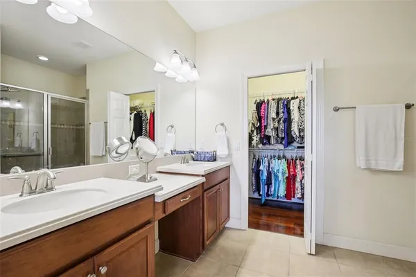 a bathroom with a double vanity sink and a mirror