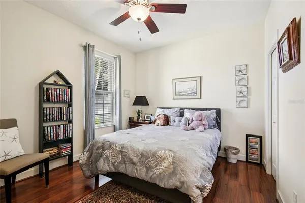 a bedroom with a bed and a bookshelf