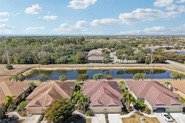 an aerial view of residential houses with outdoor space and river