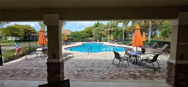 a swimming pool with outdoor seating and yard