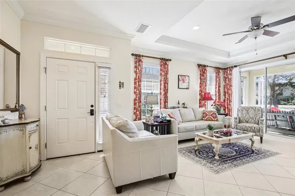 a living room with furniture and a chandelier