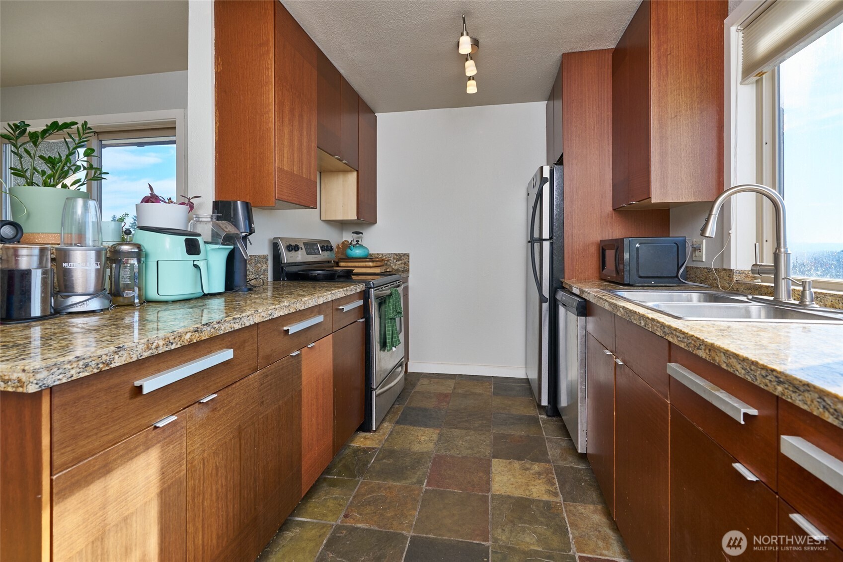 812 North 42nd Street, Unit 301 Seattle, WA 98103 - Photo 11 of 29 a kitchen with stainless steel appliances granite countertop a sink stove and refrigerator