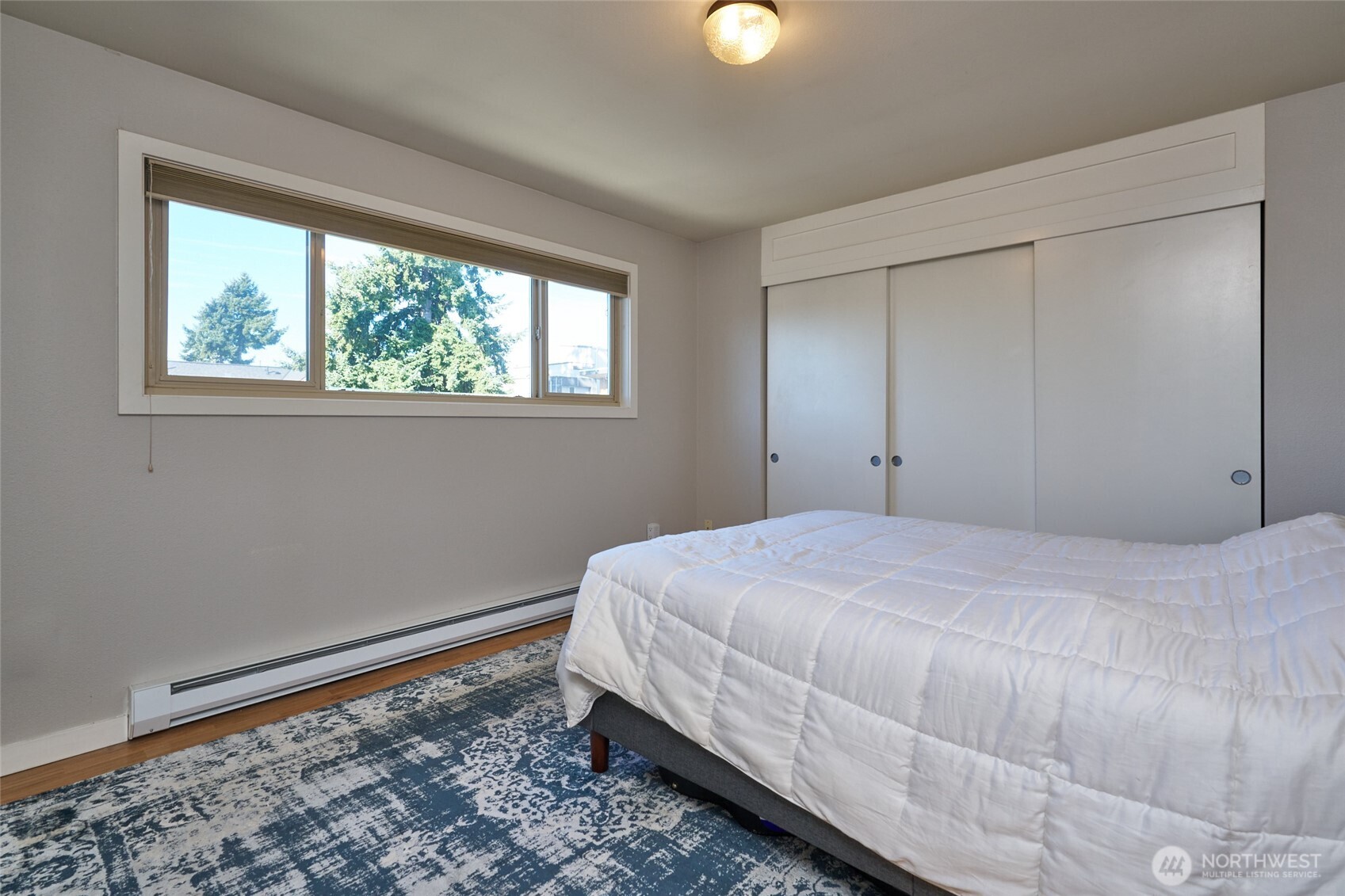 812 North 42nd Street, Unit 301 Seattle, WA 98103 - Photo 12 of 29 a bedroom with a bed and a window