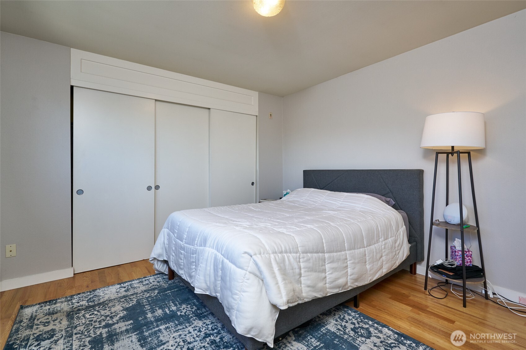 812 North 42nd Street, Unit 301 Seattle, WA 98103 - Photo 13 of 29 a bedroom with a bed and wooden floor