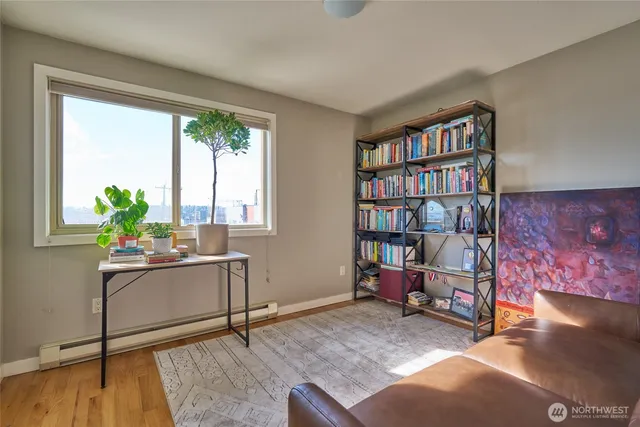 a living room with furniture and a book shelf