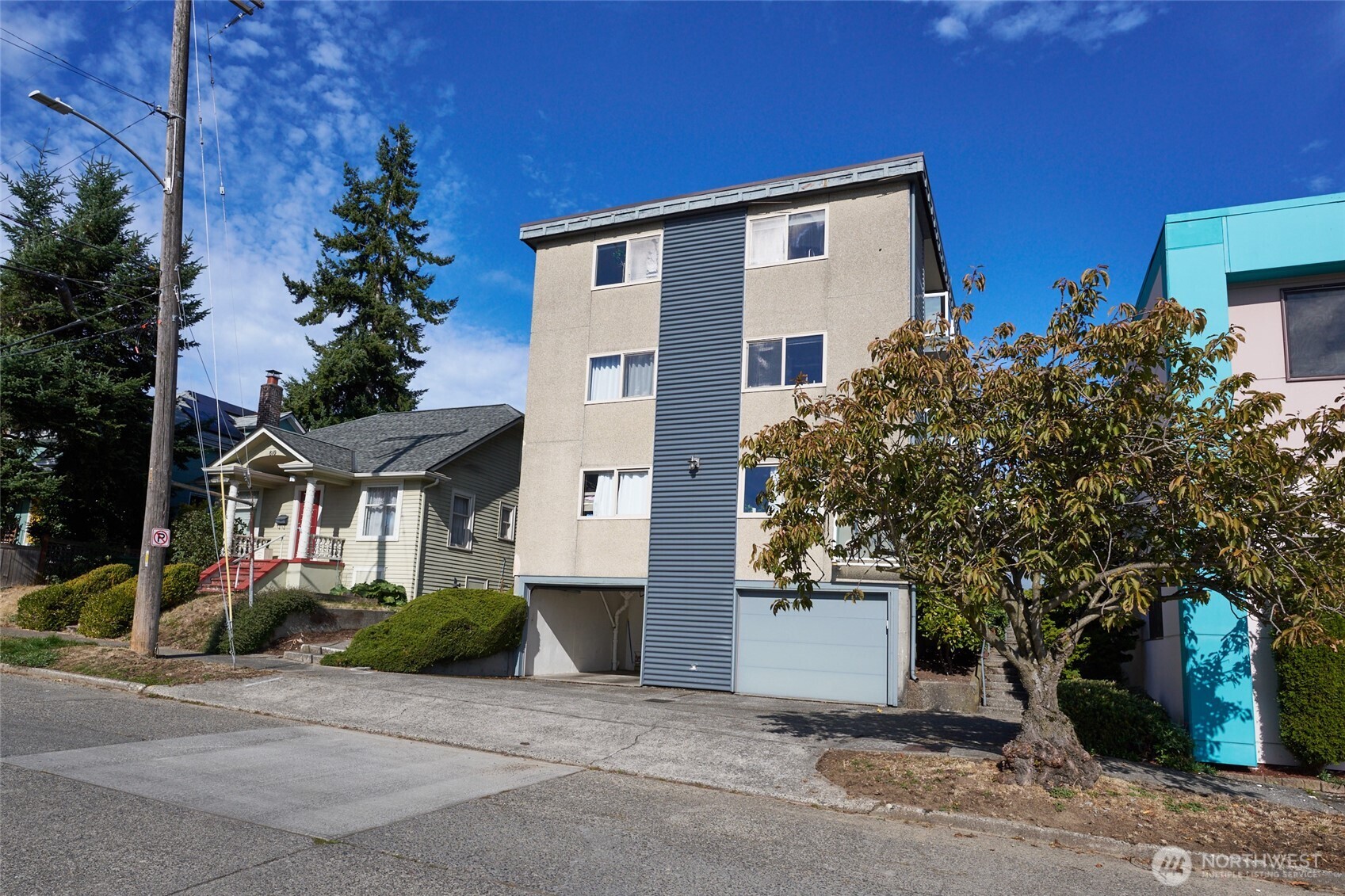 812 North 42nd Street, Unit 301 Seattle, WA 98103 - Photo 2 of 29 a front view of a house with a yard