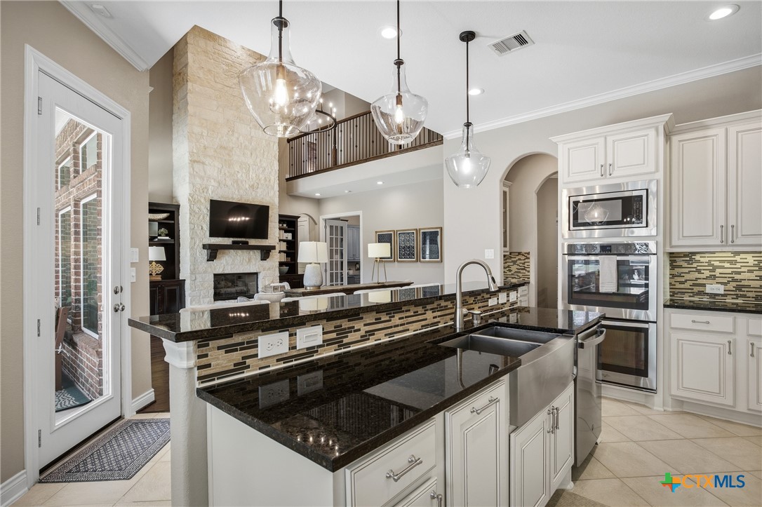 2427 Anderson Point Lane Spring, TX 77388 - Photo 16 of 46 2427 Anderson Point Ln, Spring, TX 77388 - Center island features bar, sink, and dishwasher