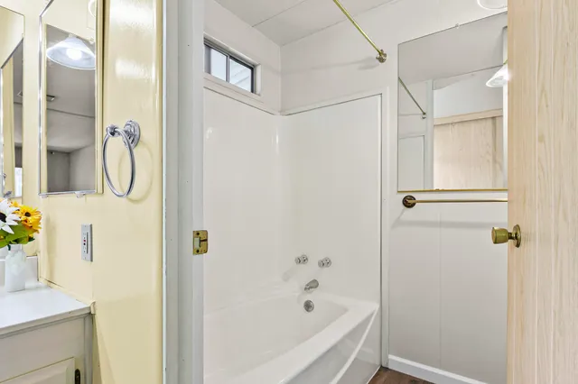 a bathroom with a bathtub and shower
