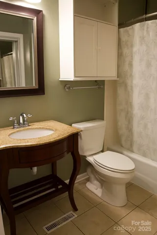 a bathroom with a sink a toilet and mirror